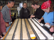 Photograph of scientists over a core table