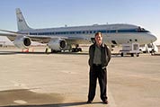 Photograph of Paul Newman standing in front of NASA's DC-8 research aircraft.