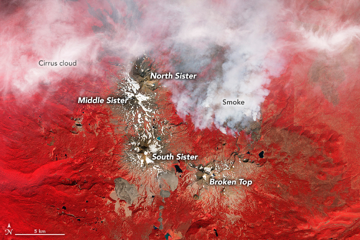 A false-color image of the Three Sisters Wilderness area and smoke from a nearby wildfire.